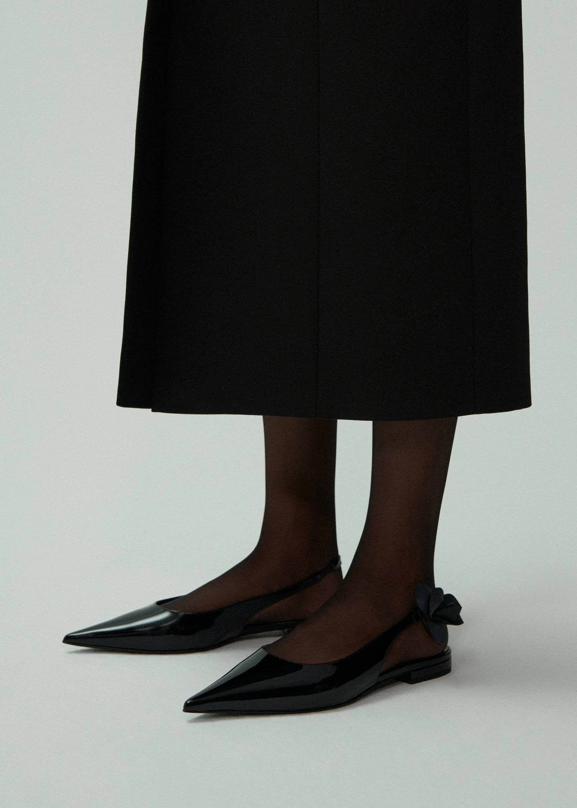 Slingback rose flats in black patent